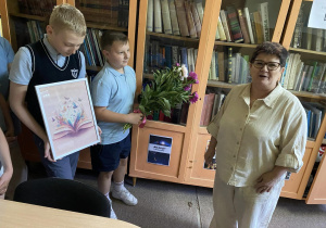 Pani Iwonka przyjmuje kwiaty i prezent.